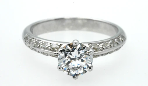 An exquisite view of a classic solitaire engagement ring featuring a dazzling diamond securely held by a six-claw setting. 