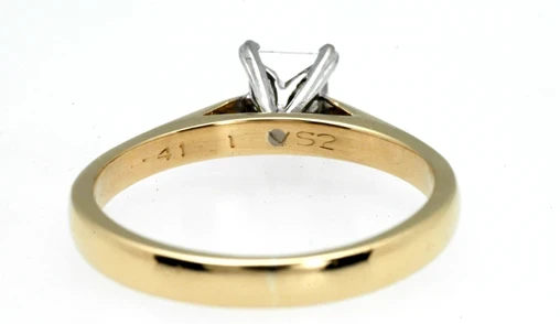 A close-up image showcasing a stunning 0.41-carat princess-cut diamond ring with a sleek platinum band.