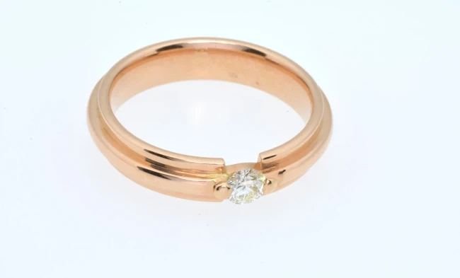 A close-up image of a stunning diamond engagement ring featuring a sparkling, round-cut diamond set on a polished platinum band. 