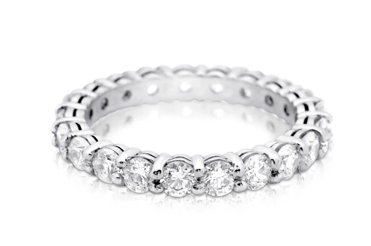 An exquisite full-diamond eternity ring featuring a continuous row of meticulously cut diamonds set in a sleek, polished band.