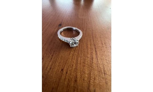A stunning modern diamond solitaire ring elegantly displayed against a soft, gradient background. 