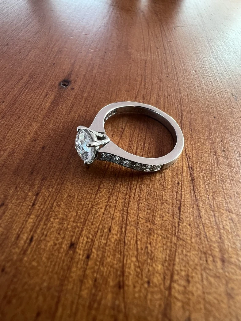 A stunning modern diamond solitaire ring featuring a beautifully cut, brilliant diamond set in a sleek, minimalist platinum band.