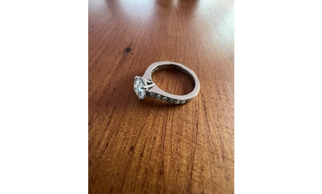 A stunning modern diamond solitaire ring featuring a beautifully cut, brilliant diamond set in a sleek, minimalist platinum band.