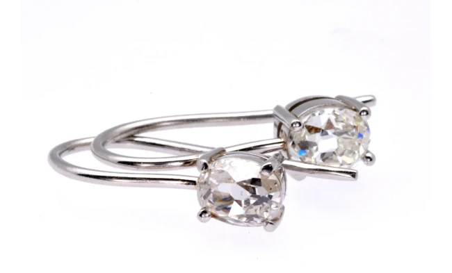 An exquisite pair of old-cut diamond earrings showcased on a dark velvet background, highlighting their intricate craftsmanship and timeless elegance. Available at Aurum Fine Jewellery, Auckland NZ.