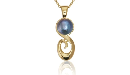 A captivating image of a Pacific blue pearl pendant from Aurum Fine Jewellery, Auckland NZ, showcasing a lustrous pearl set in an eloquent silver mount with intricate detailing. 