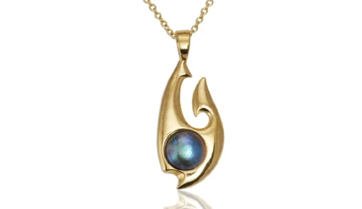 A stunning Pacific blue pearl pendant featuring a lustrous, deep blue pearl set in a delicate silver frame. 