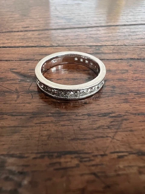 A stunning diamond hoop ring featuring a symmetrical circle of brilliant-cut diamonds set in a sleek band, exuding timeless elegance and sophistication. 