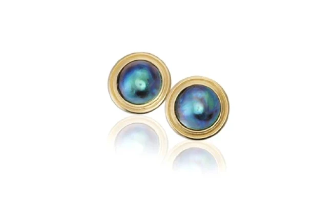 An elegant pair of Pacific pearl earrings, each featuring a lustrous, large, and perfectly round pearl hanging gracefully from a delicate silver setting. 